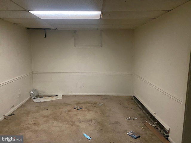 finished basement featuring a paneled ceiling