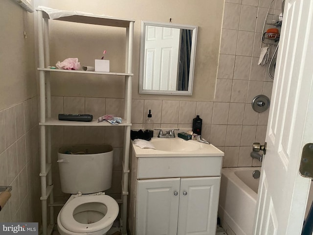 full bath with vanity, tile walls, toilet, and shower / tub combination