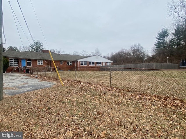 view of yard featuring aphalt driveway and fence private yard