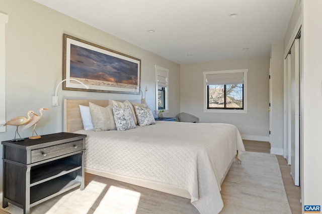 bedroom featuring recessed lighting, wood finished floors, and baseboards