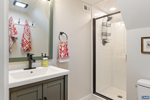 full bath featuring visible vents, a shower stall, vanity, and toilet