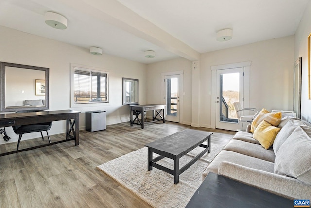 living area featuring light wood-type flooring and baseboards