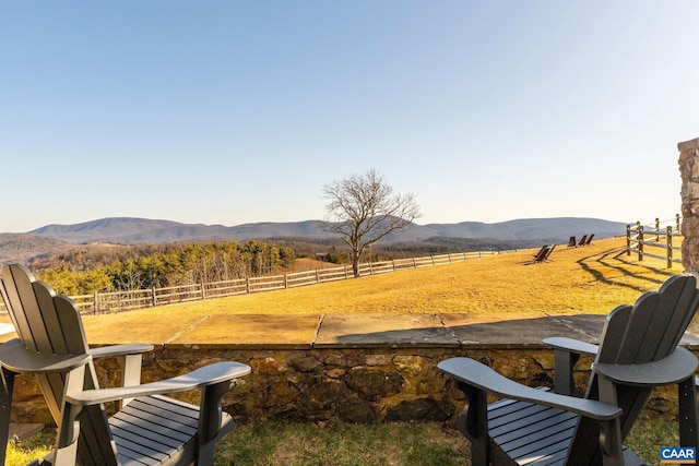 view of yard with a mountain view, a rural view, and fence