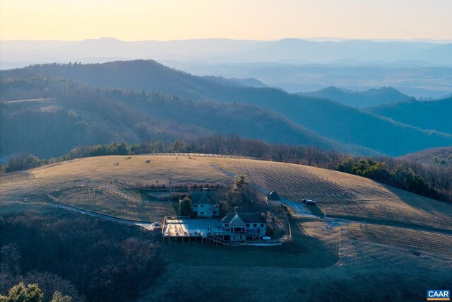 birds eye view of property with a wooded view and a mountain view