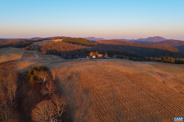 aerial view at dusk featuring a rural view and a mountain view