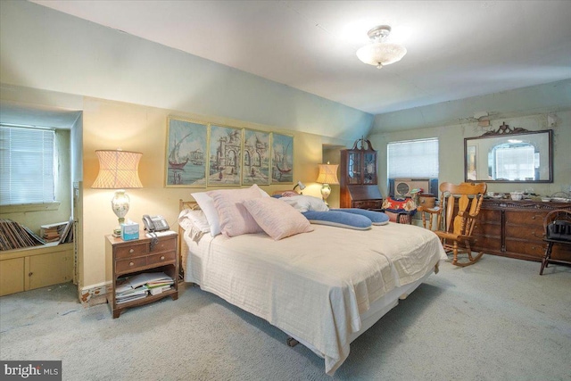 bedroom featuring carpet floors and vaulted ceiling