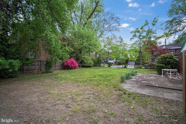 view of yard featuring fence and a patio area