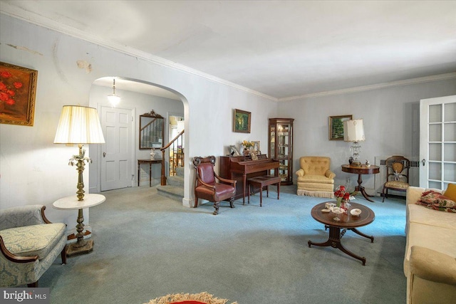 carpeted living room with arched walkways, stairway, and crown molding