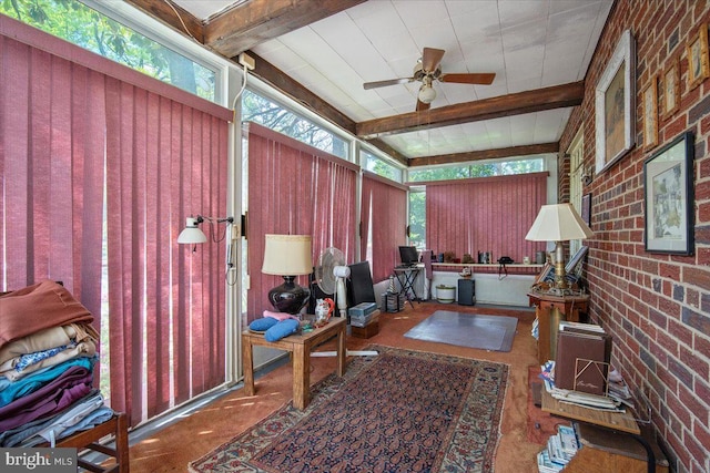 home office featuring brick wall, ceiling fan, and beam ceiling