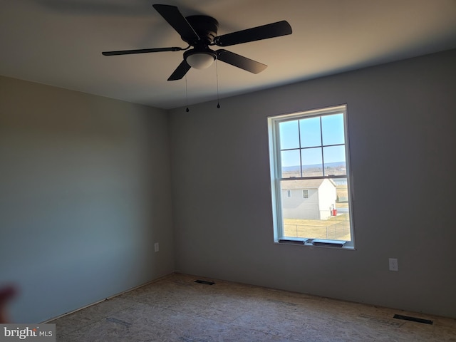 unfurnished room featuring visible vents and a ceiling fan