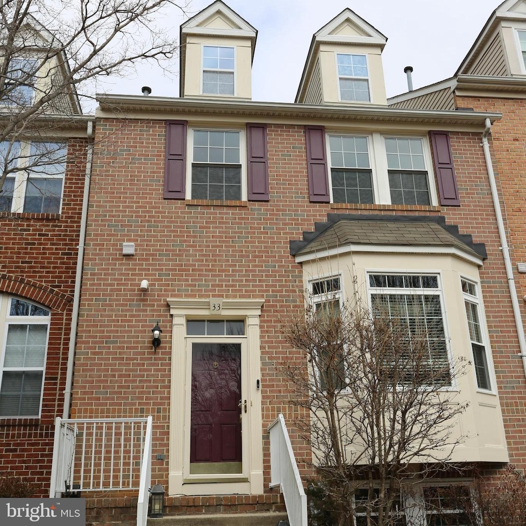 townhome / multi-family property featuring brick siding