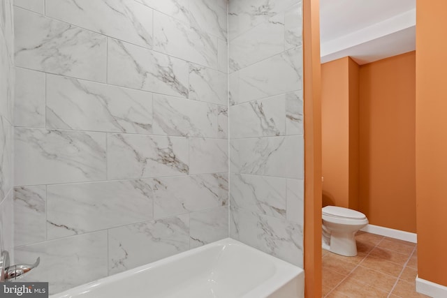 bathroom featuring tile patterned floors, toilet, and baseboards