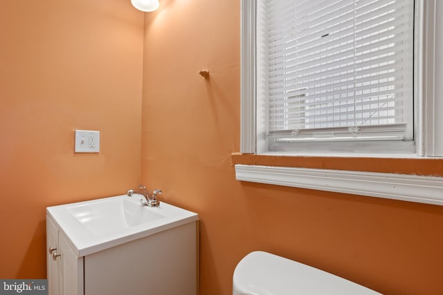 bathroom featuring toilet and vanity