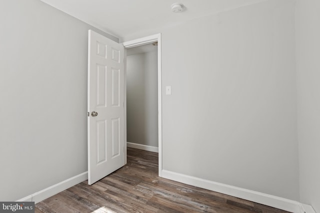 unfurnished room with baseboards and wood finished floors