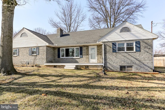 view of front of house with a front yard, roof with shingles, and a chimney