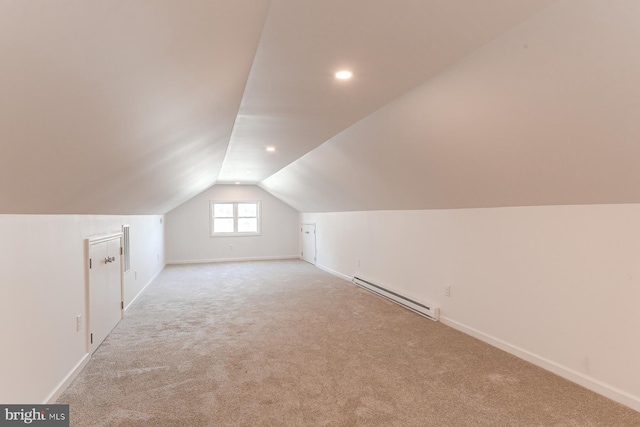 additional living space featuring baseboards, carpet floors, baseboard heating, and vaulted ceiling