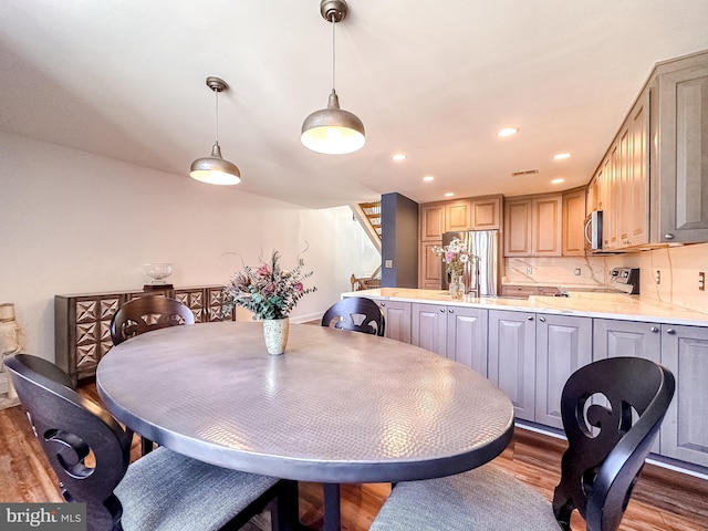 dining space with stairway, recessed lighting, wood finished floors, and visible vents