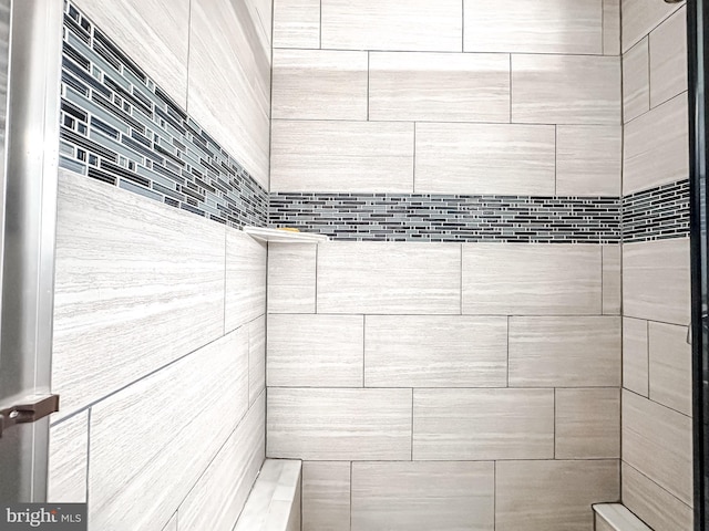 full bathroom with a tile shower