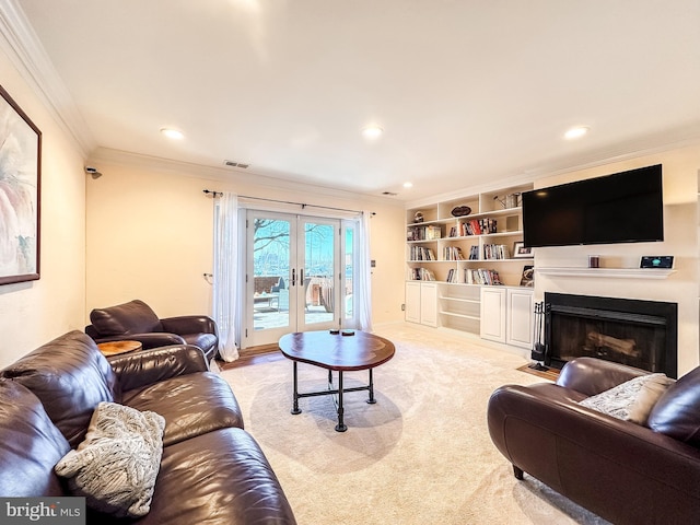 living room with visible vents, light carpet, ornamental molding, and a fireplace with flush hearth