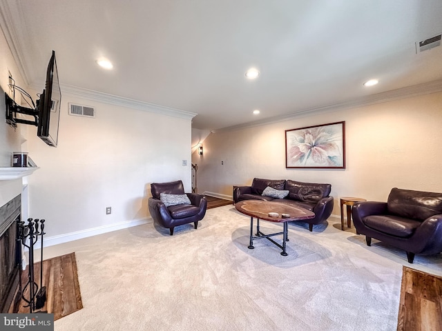 carpeted living area with visible vents, a fireplace, and ornamental molding