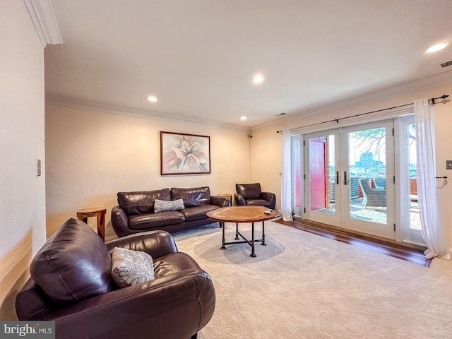 living area with recessed lighting, light colored carpet, and ornamental molding