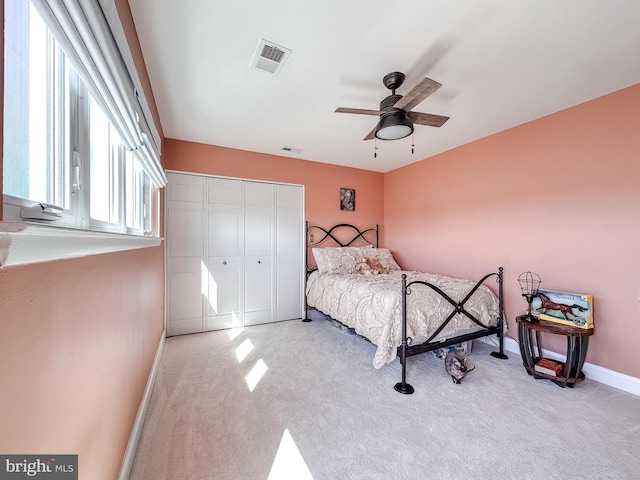 bedroom with visible vents, ceiling fan, baseboards, carpet, and a closet