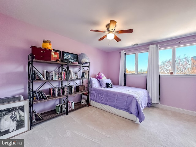 carpeted bedroom featuring visible vents, baseboards, and a ceiling fan