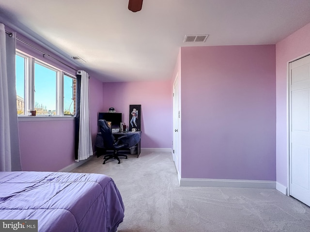 carpeted bedroom with visible vents, baseboards, and ceiling fan