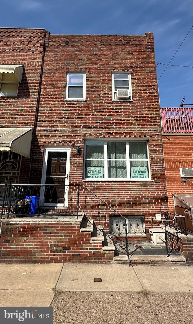 view of property with brick siding