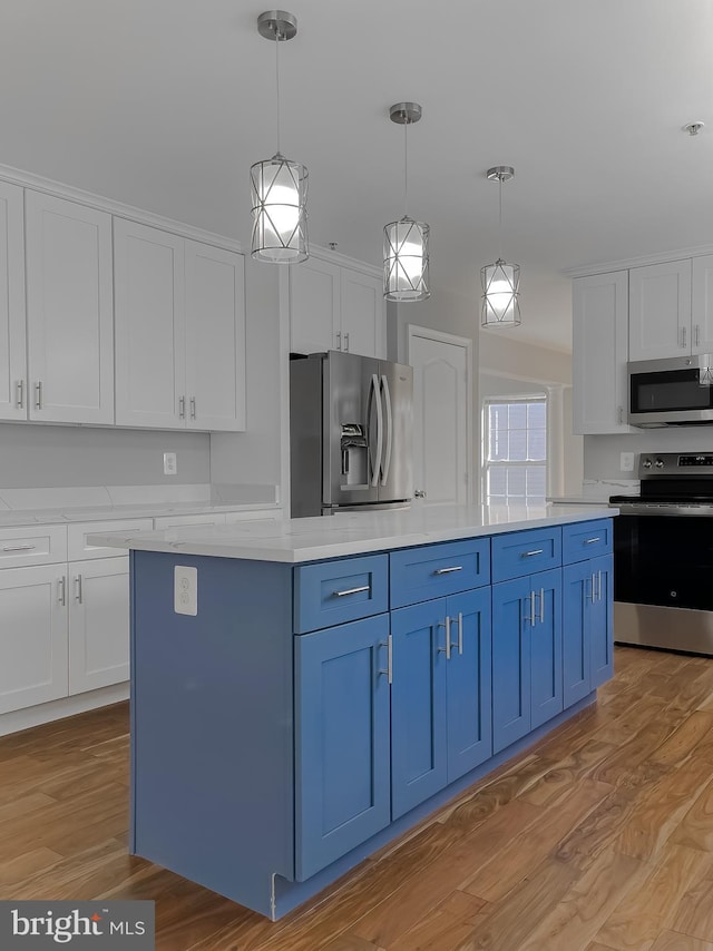 kitchen with blue cabinetry, white cabinetry, stainless steel appliances, and light wood-type flooring