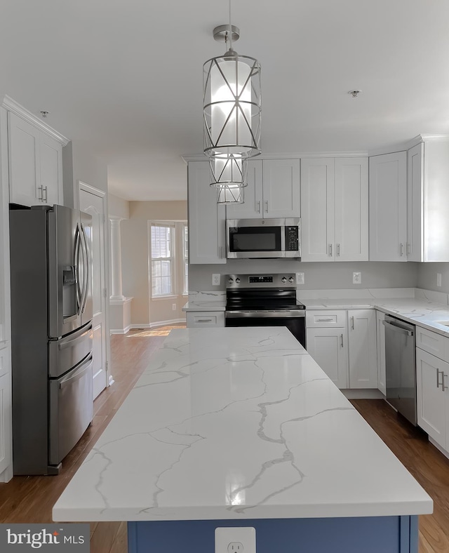 kitchen featuring white cabinetry, wood finished floors, appliances with stainless steel finishes, and a center island