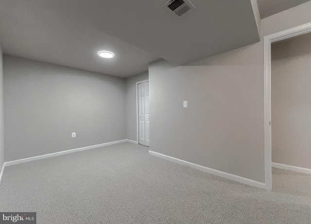 basement with visible vents, baseboards, and carpet