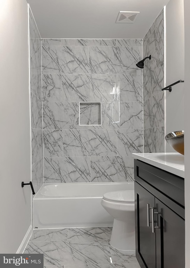 full bathroom featuring visible vents, toilet, bathing tub / shower combination, marble finish floor, and vanity