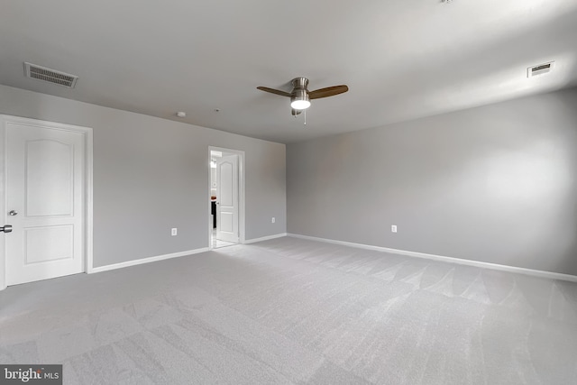 spare room featuring visible vents, baseboards, light colored carpet, and ceiling fan