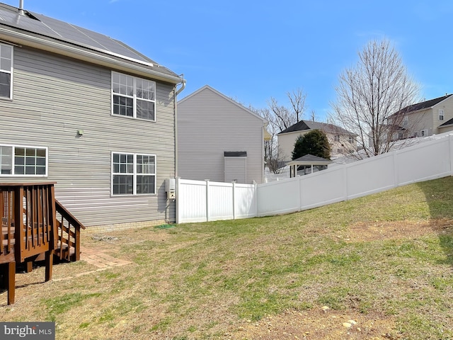 view of yard with a deck and fence