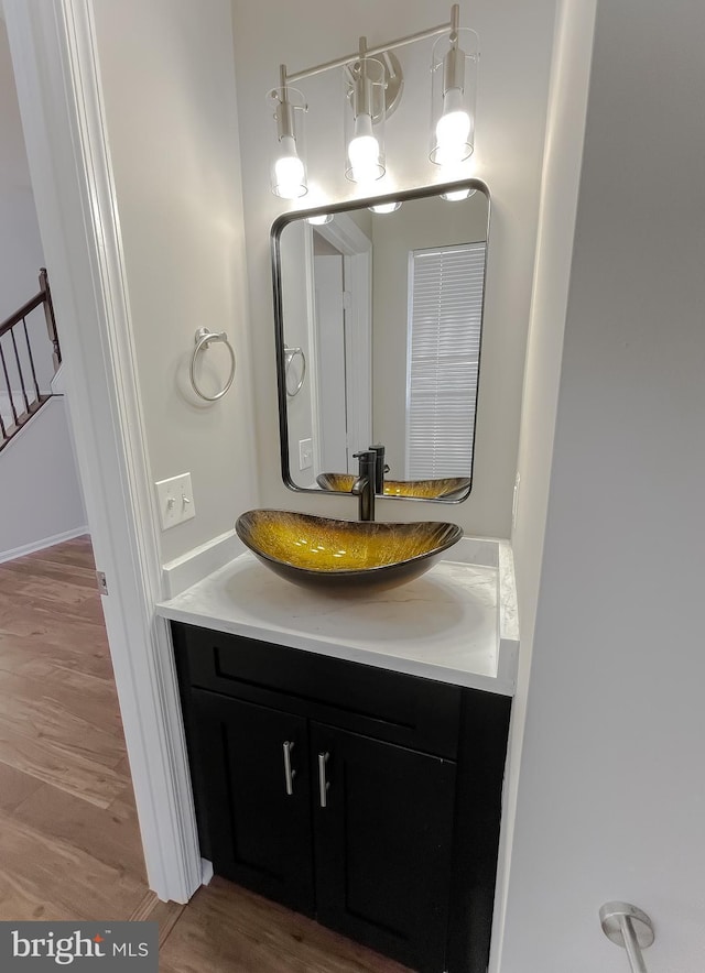 bathroom with vanity and wood finished floors