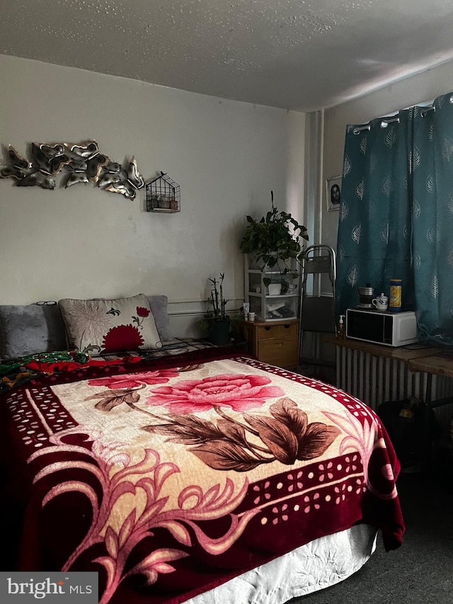 carpeted bedroom with a textured ceiling