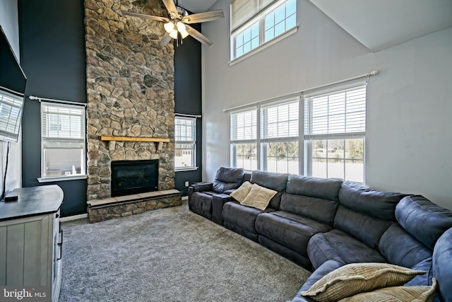 living room featuring carpet flooring, a ceiling fan, and plenty of natural light