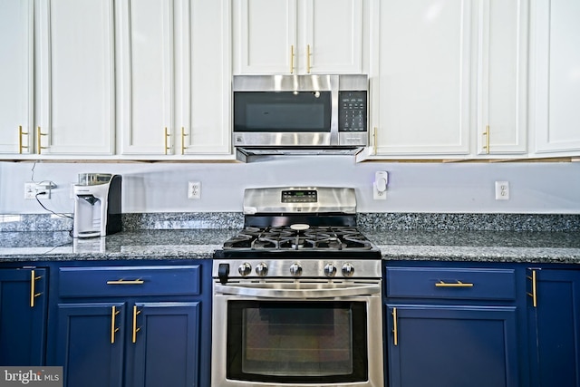 kitchen featuring white cabinets, blue cabinets, and appliances with stainless steel finishes