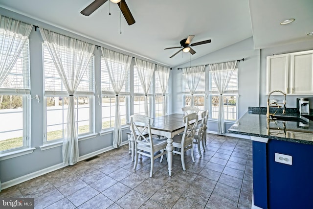 sunroom / solarium featuring visible vents, ceiling fan, and vaulted ceiling