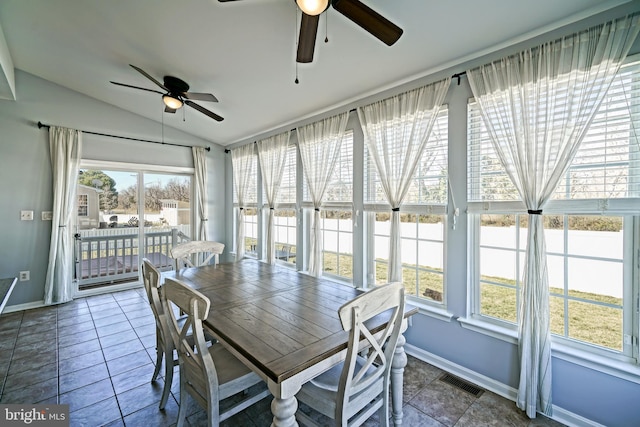 unfurnished sunroom with visible vents, a ceiling fan, and vaulted ceiling