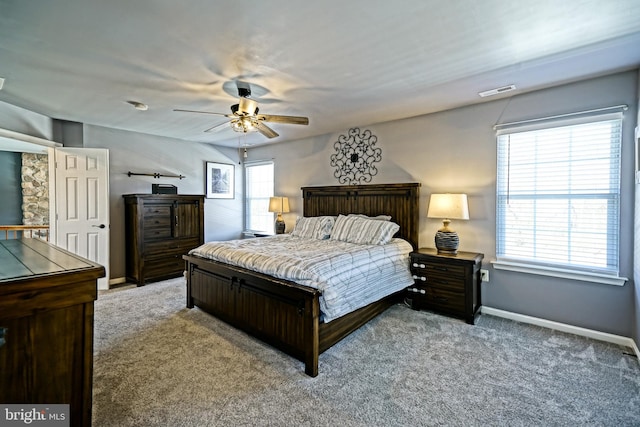 bedroom with visible vents, multiple windows, baseboards, and carpet