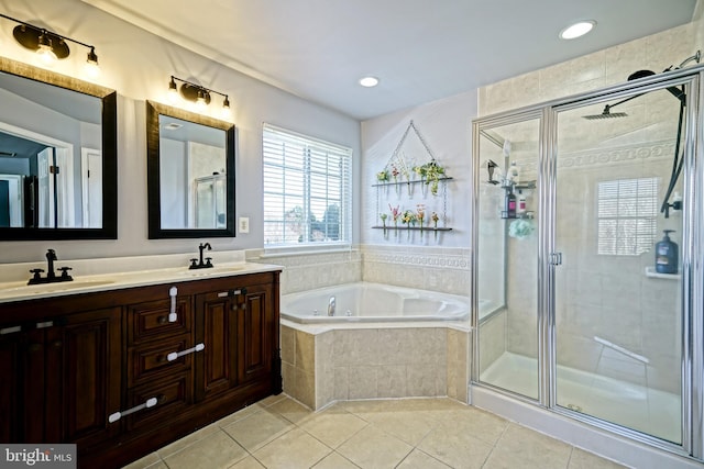 bathroom with tile patterned flooring, a bath, a stall shower, and a sink