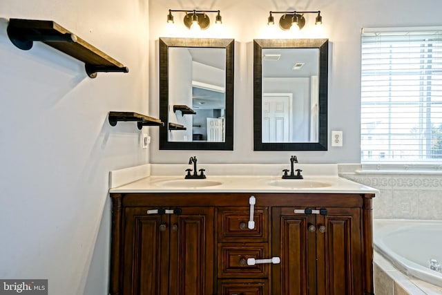 full bath with double vanity, a bath, and a sink