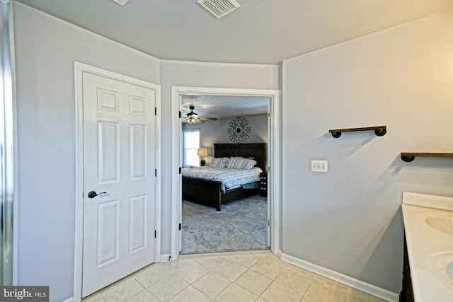 ensuite bathroom featuring visible vents, double vanity, ceiling fan, tile patterned floors, and connected bathroom