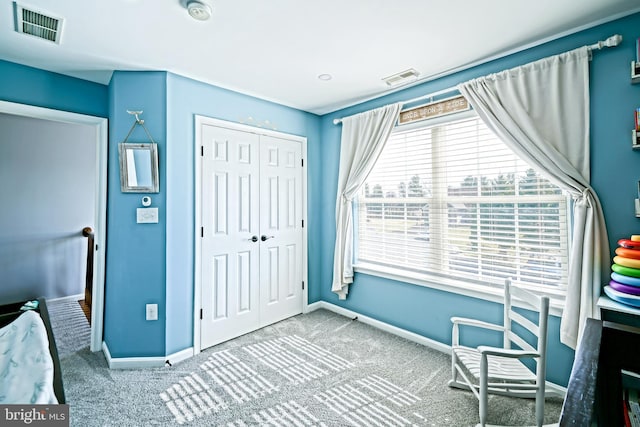 unfurnished bedroom with visible vents, a closet, and carpet flooring