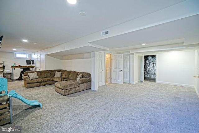 carpeted living area with recessed lighting, visible vents, and baseboards