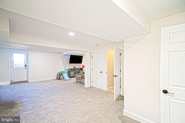 below grade area featuring baseboards and carpet floors