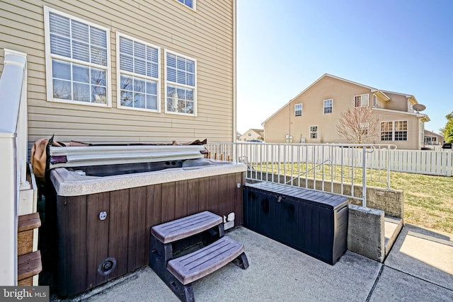 view of patio with fence and a hot tub