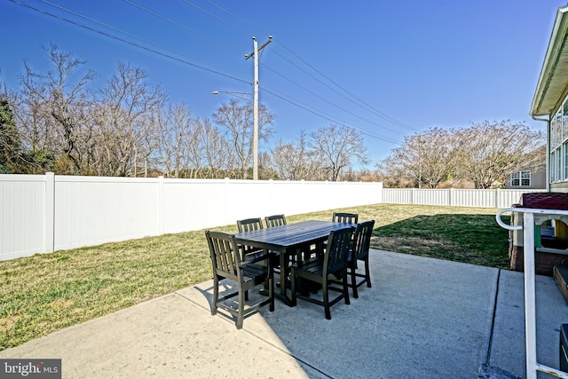 view of patio with a fenced backyard and outdoor dining space